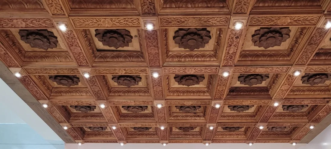 Coffered teak ceiling carved with lotus medallions